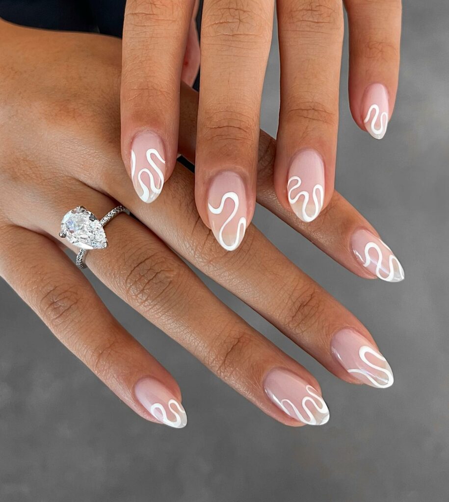 28 Latest Nude And White Nail Designs To Try in 2024! 10 Nude And White Small Almond Swirl Nails