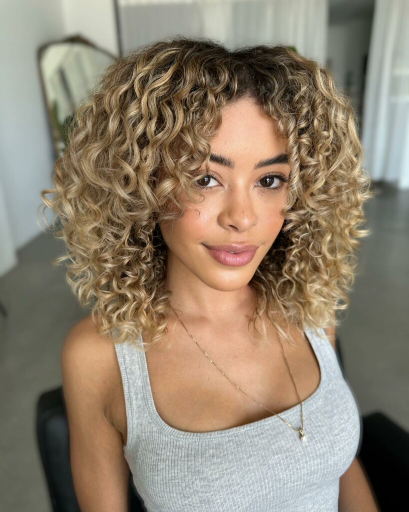 25 Curly Hair Perm Ideas to Transform Your Look in 2024 16 Medium Bronde Curly Hairstyle