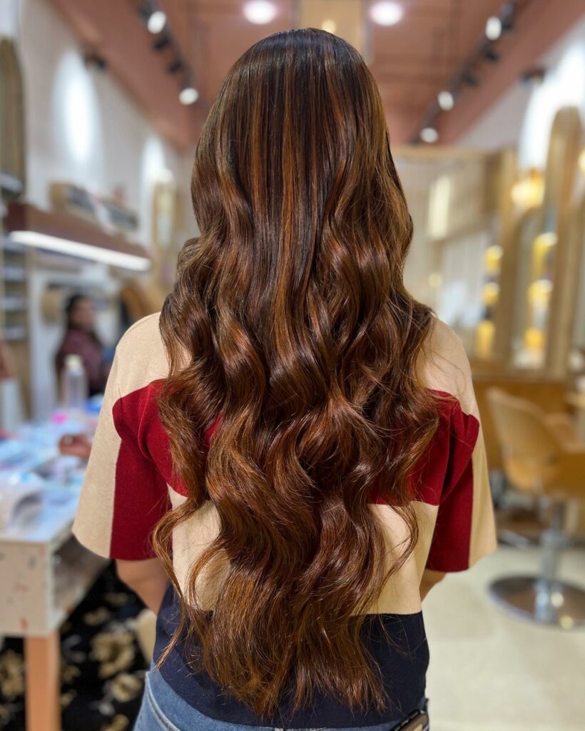 35 Reddish Brown Hair Color Ideas to Try in 2024 33 Brown Wavy Locks with Copper Touches