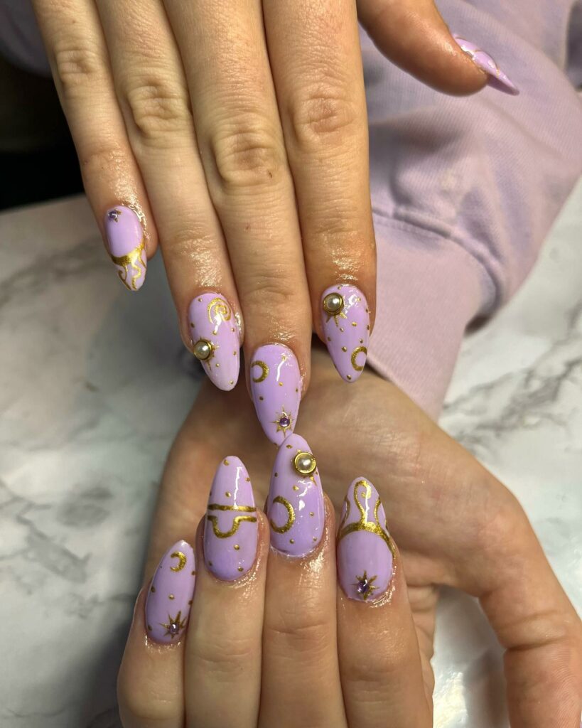 20 Latest Purple And Gold Nail Ideas To Try In 2024! 17 Purple Nails With Gold Moon And Stars Design