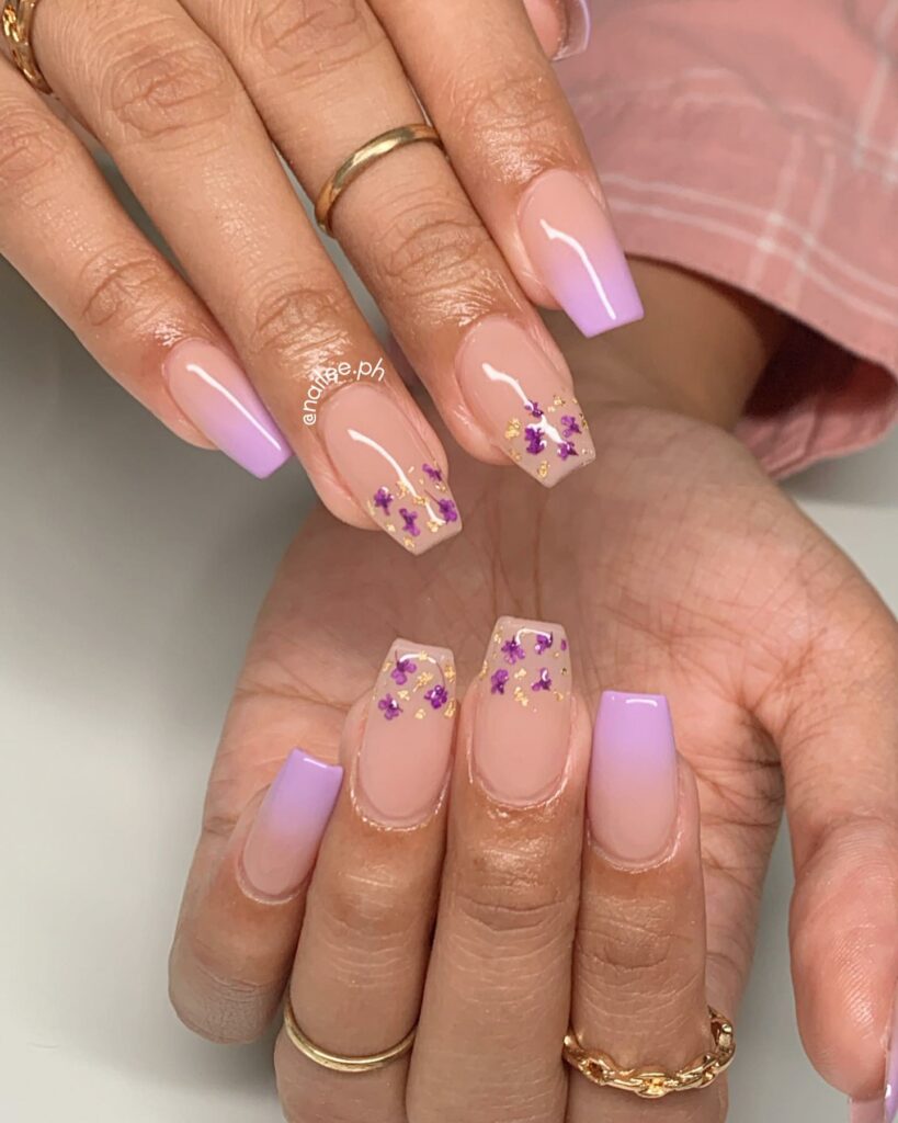 20 Latest Purple And Gold Nail Ideas To Try In 2024! 29 Purple Short Coffin Nails With Flower And Gold Flakes Design