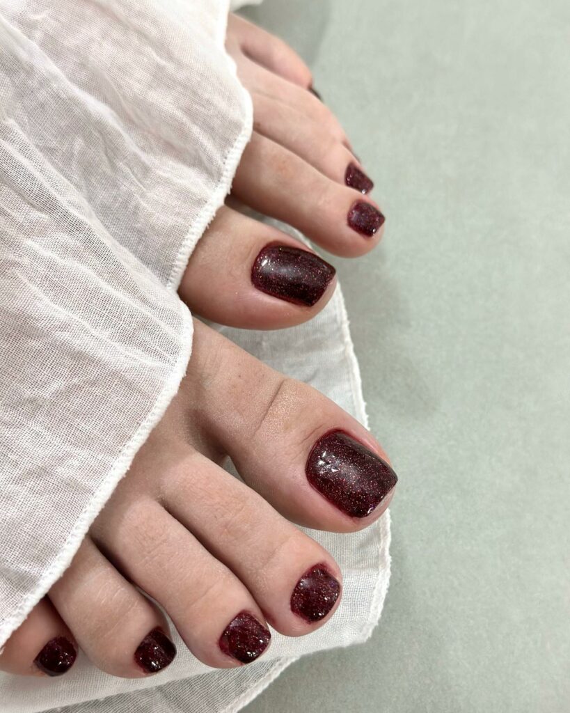 20 Latest Burgundy Pedicure Designs To Try In 2024! 12 Matte Burgundy Pedicure With Glitters