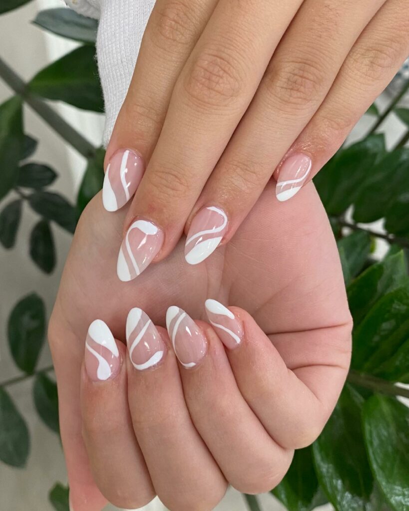 Admire 25 White Almond Nail Designs of 2024 18 White Swirl Almond Nails