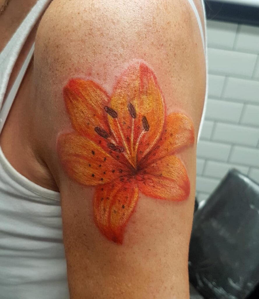 AMAZING LILY TATTOO DESIGNS + A DEEP DIVE INTO THEIR MEANINGS IN 2024 17 Orange Lily Tattoo