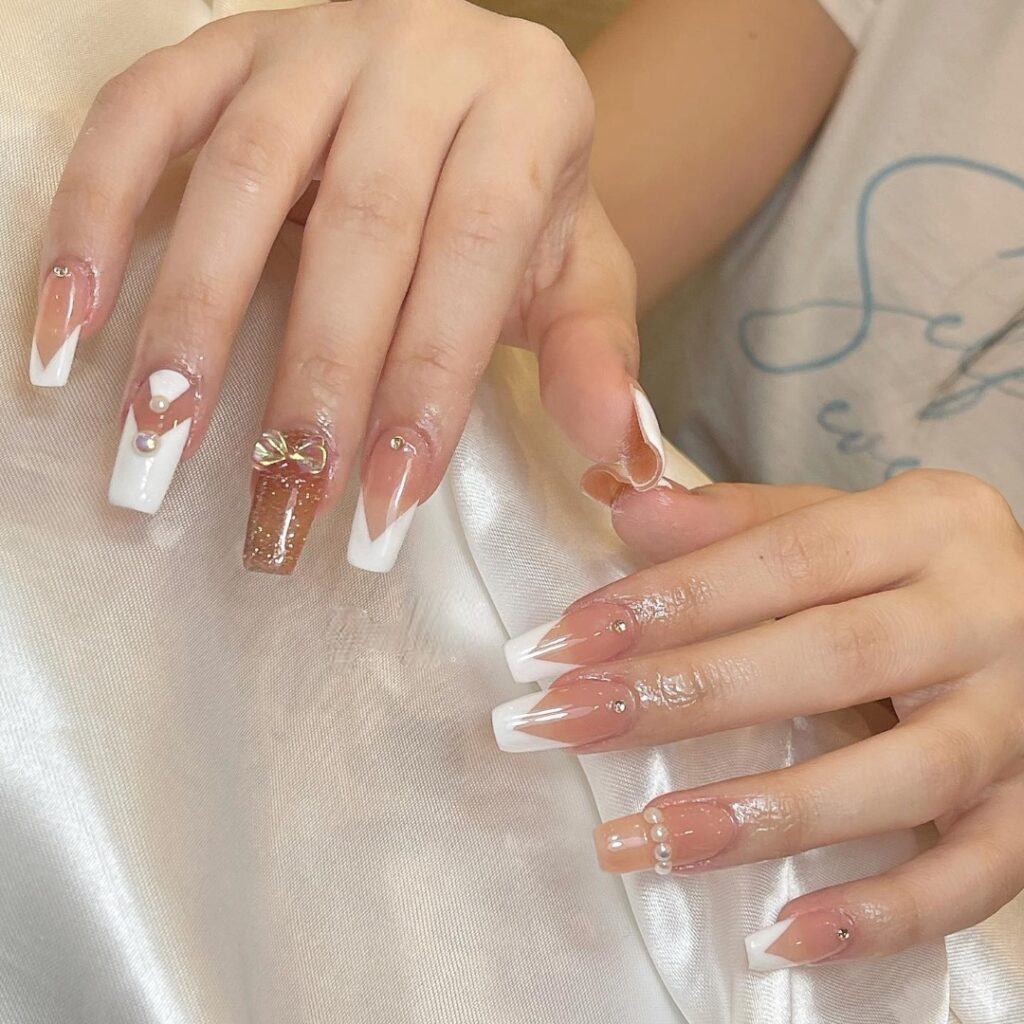 50 Latest V French Tip Coffin Nail Designs To Try In 2024! 39 White V Cut French Tip Nails With Gold Glitter