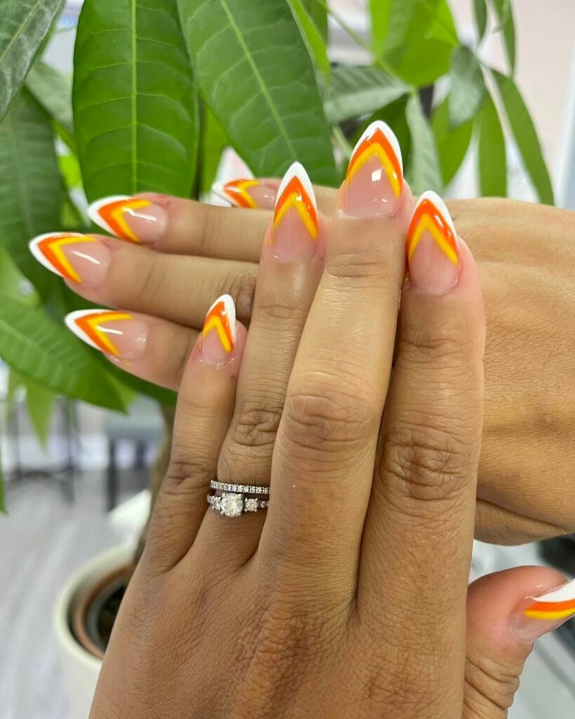 20 Latest Candy Corn Nail Design To Try In 2024! 28 Candy Corn V Tip Almond Nails