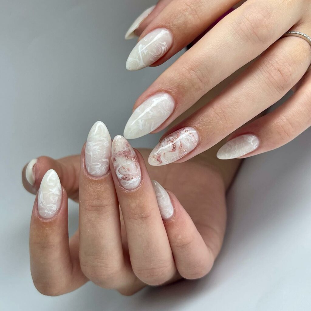 Embrace Elegance with 15 White Marble Nail Designs in 2024 11 White Marble Almond Nails