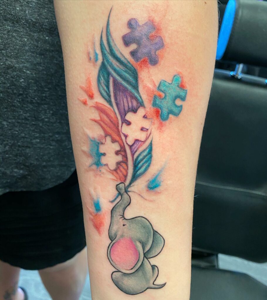 12+ Small Autism Tattoo Ideas To Inspire You! 12 Adorable Autism Puzzle Piece Tattoo Design With Baby Elephant