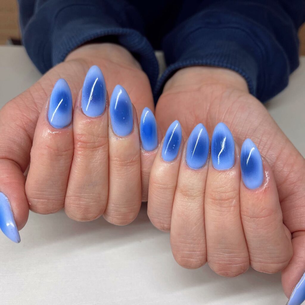 Experiment with 30 Stunning Blue Ombré Nails for 2024 13 Airbrushed blue ombre nails