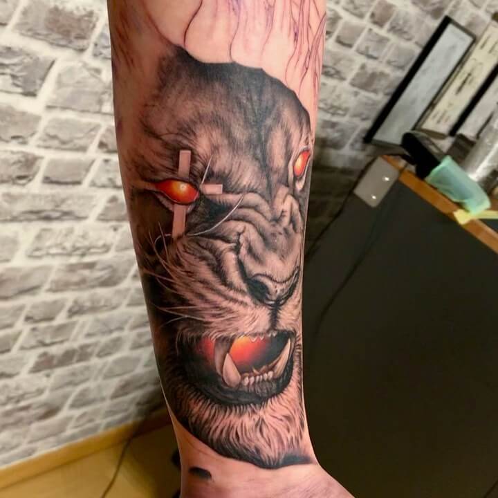 11+ Lion And Cross Tattoo Ideas That Will Blow Your Mind! 18 Angry Lion with Cross Eye Tattoo