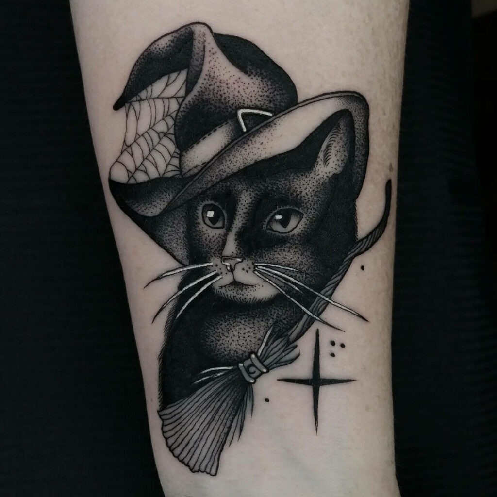 33 Halloween Tattoo Ideas for 2024 33 Black Cat With Witch's Broomstick Halloween Tattoo