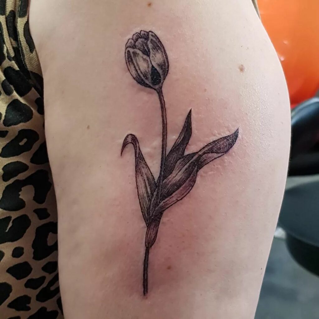 AMAZING TULIP TATTOO DESIGNS + MEANINGS TO INSIRE YOU IN 2024 15 Black Tulip Tattoos