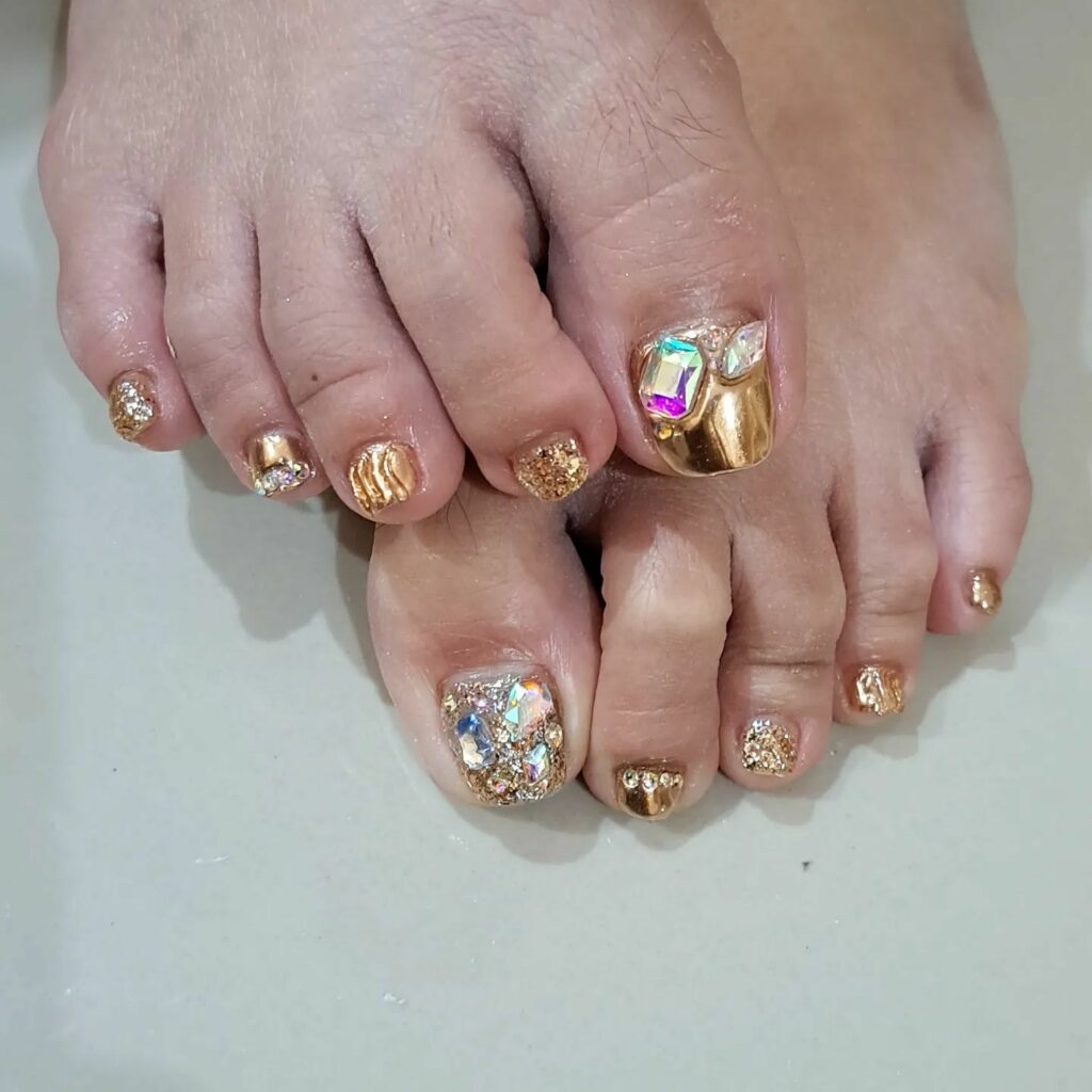 30 Gold Pedicure Ideas to Add Glamour to Your Look in 2024 14 Gold Pedicure With Stones Design