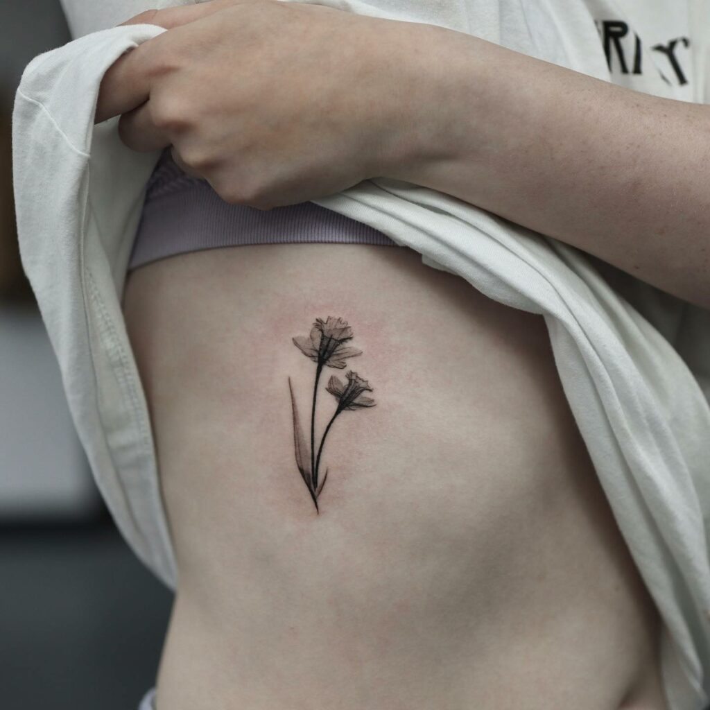 11+ Women Ribs Tattoo Ideas That Will Blow Your Mind! 17 Black And White Daffodil Tattoo