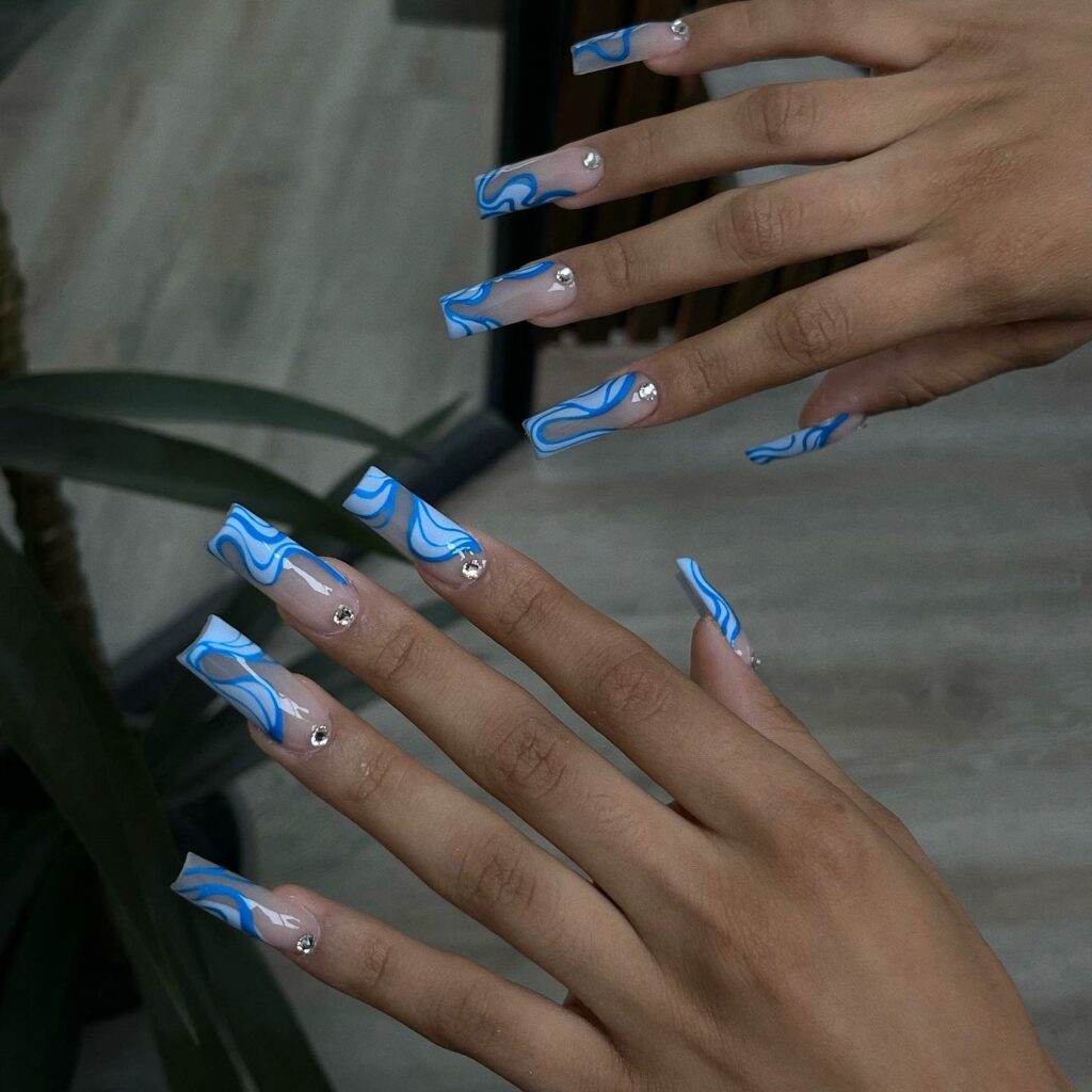 34 Latest Blue Acrylic Nail Designs To Try in 2024 35 Intricate Blue Swirl with Gem-Encrusted Acrylic Nails