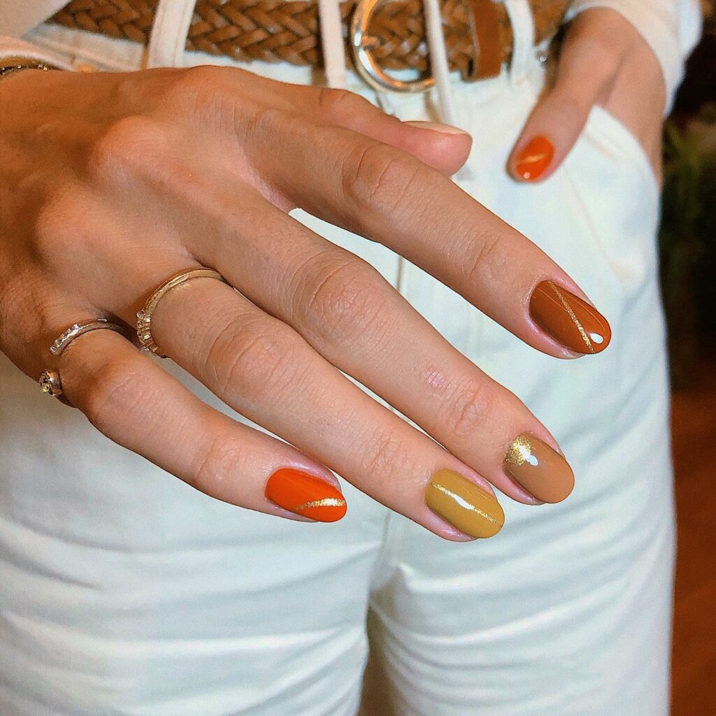 Fall in Love with 57 Short Fall Nail Designs in 2024 31 Brown Short Fall Nails with Glitters