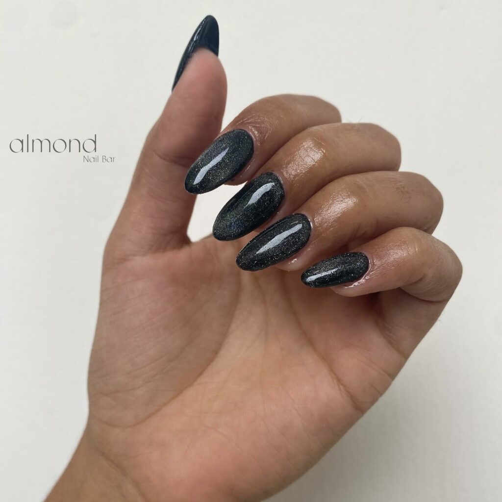 30 Latest Black Almond Nail Ideas To Try In 2024! 42 Mysterious Sheen of Cat Eye Black Almond Nails