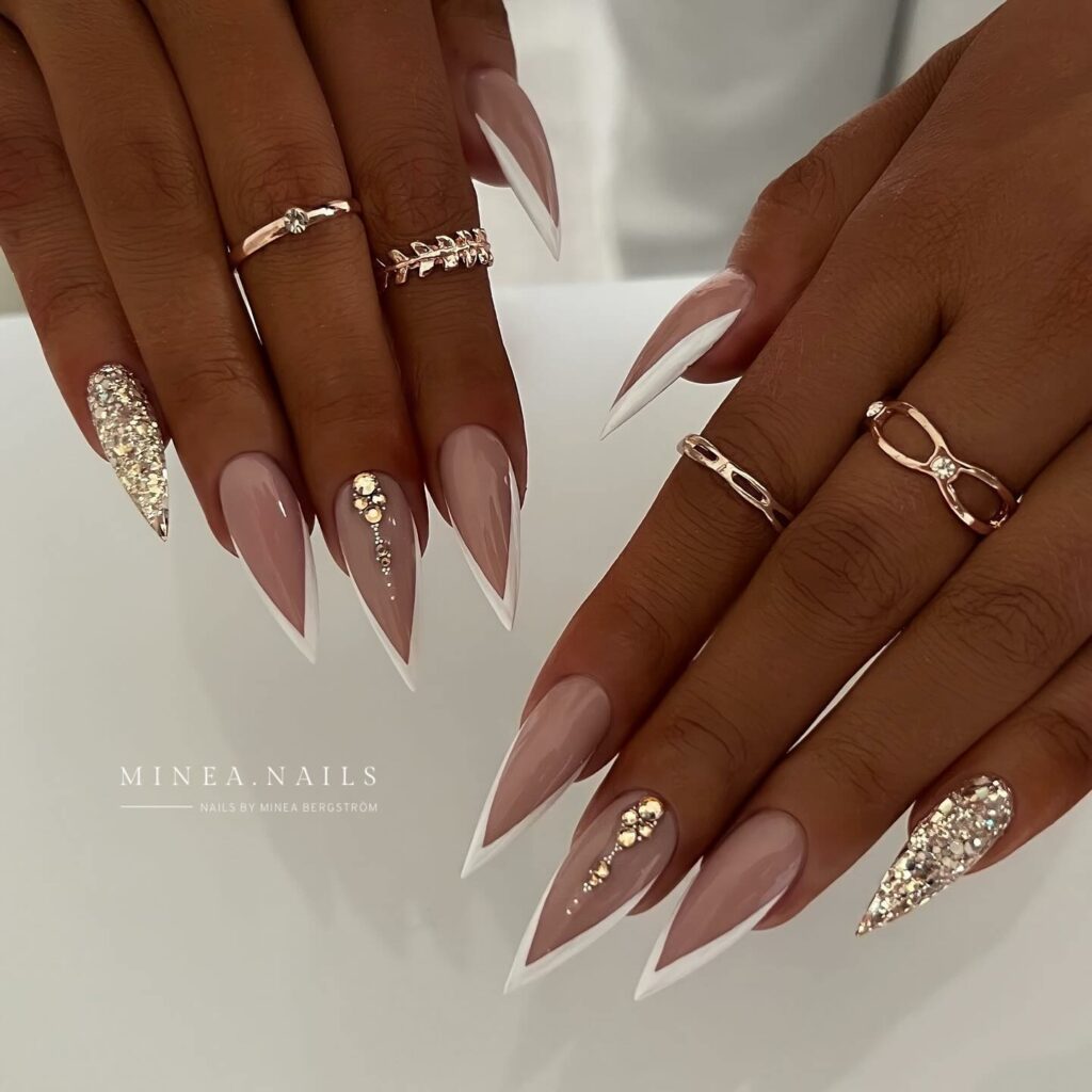 35 Latest Short Stiletto Nail Ideas to Try in 2024! 10 Chic Nude Short Stiletto Nails with Glitter Accents