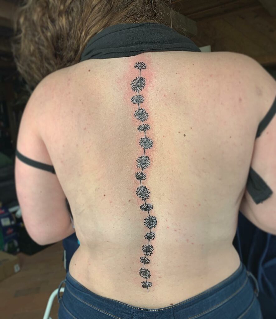11+ Flower Spine Tattoo Ideas That Will Blow Your Mind! 17 Dainty Spine Tattoos With Daisy Flowers