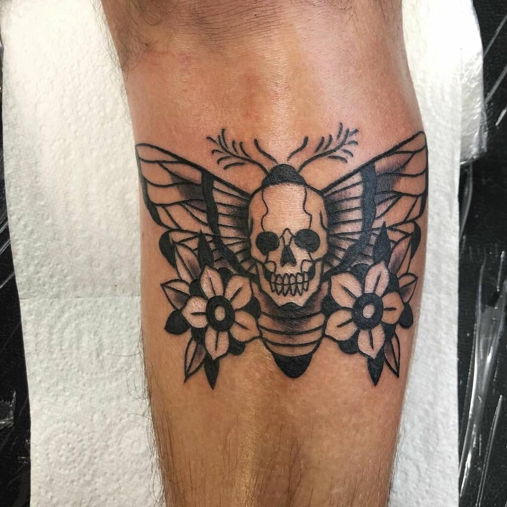 12+ Death Moth Tattoo Ideas To Inspire You! 16 Death Moth With A Pair Of Flowers Tattoo