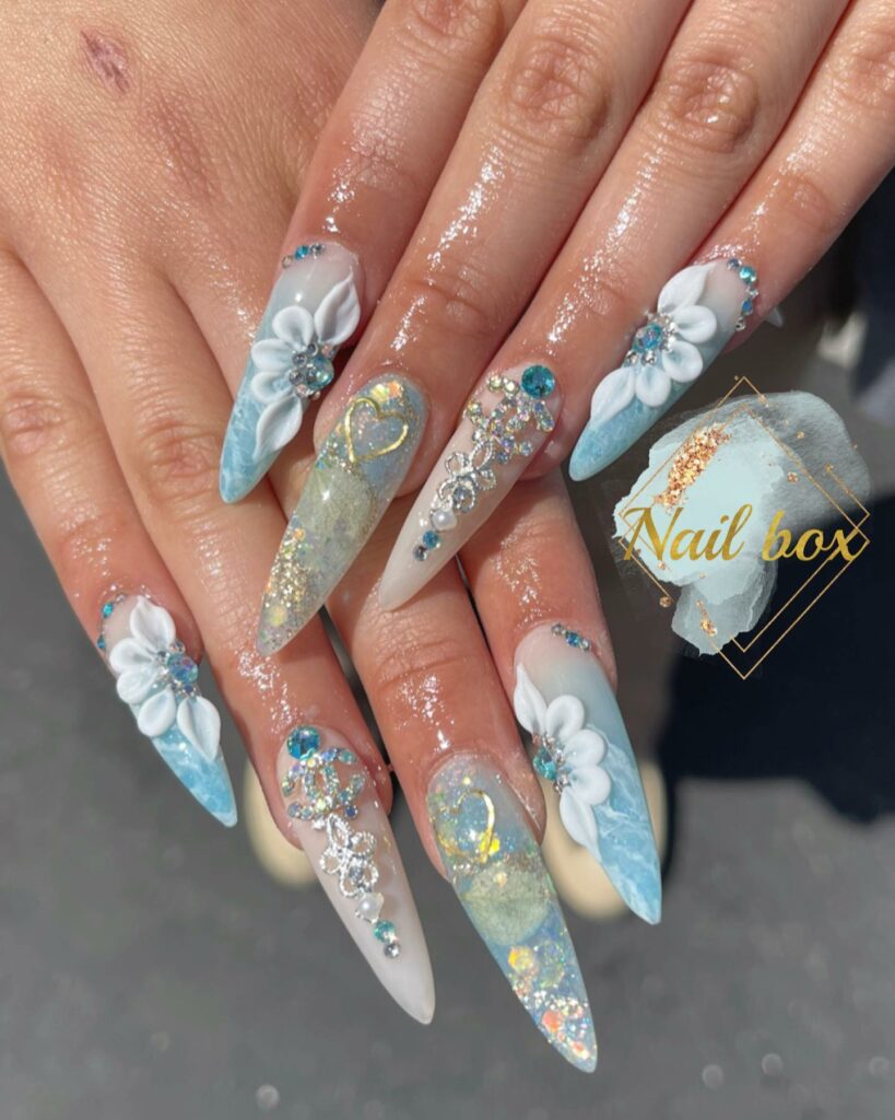 34 Latest Blue Acrylic Nail Designs To Try in 2024 26 Elegant Blue Tip Acrylic Nails with Floral Art