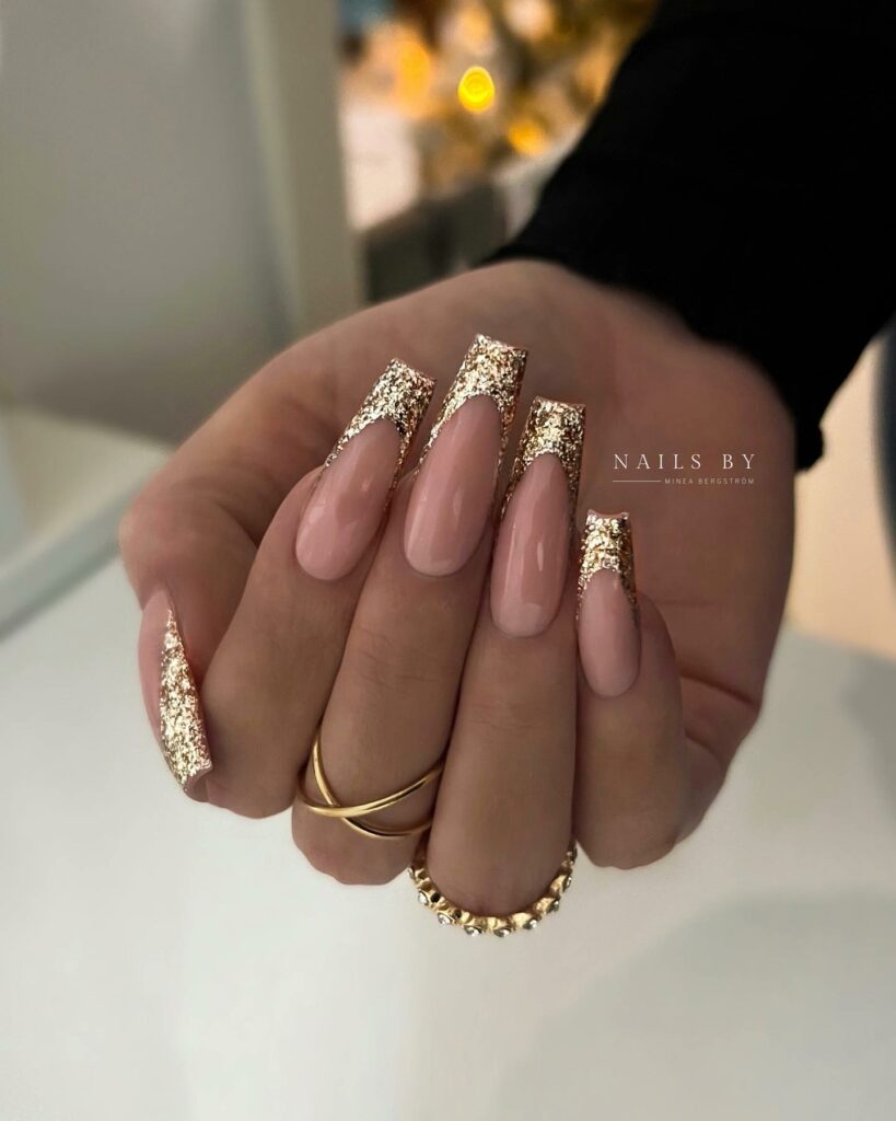 Celebrate with 30 Nude Christmas Nail Ideas in 2024 41 French Gold Glitter Nude Christmas Nails