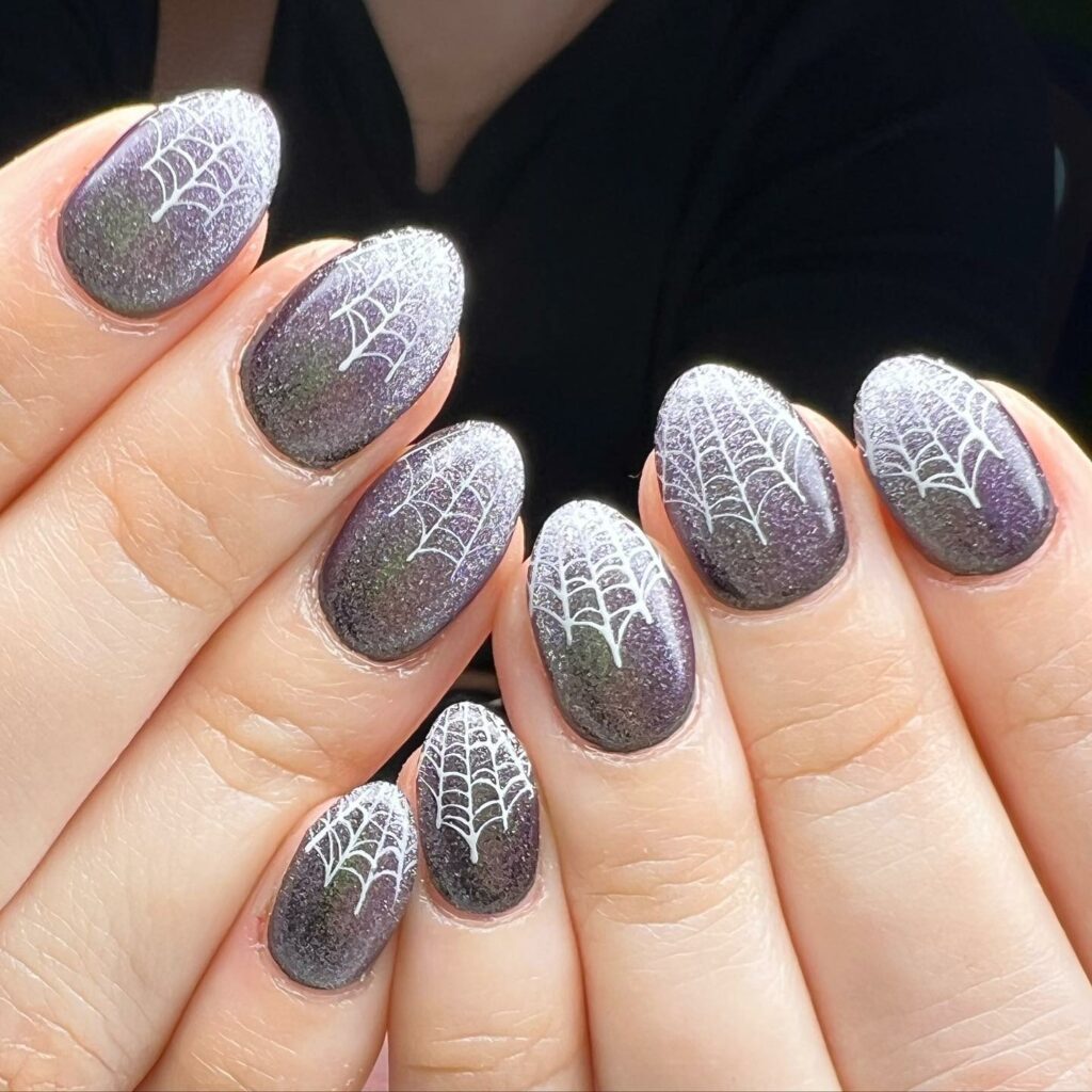 Get Spooky with 33 Black Halloween Nails To Try in 2024 40 Glitter spider web nails