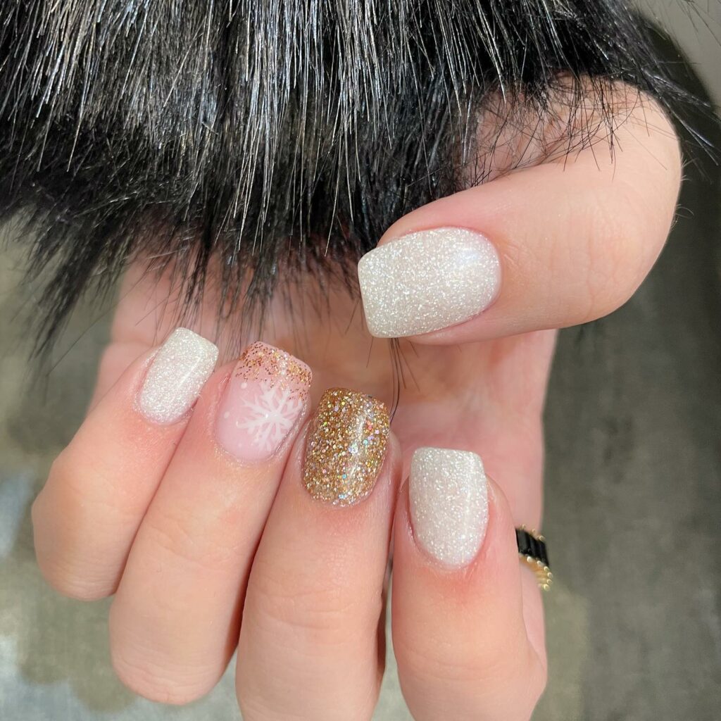 44 Latest Snowflake Nail Ideas To Try In 2024! 23 Shimmering Gold with Snowflake Sparkles