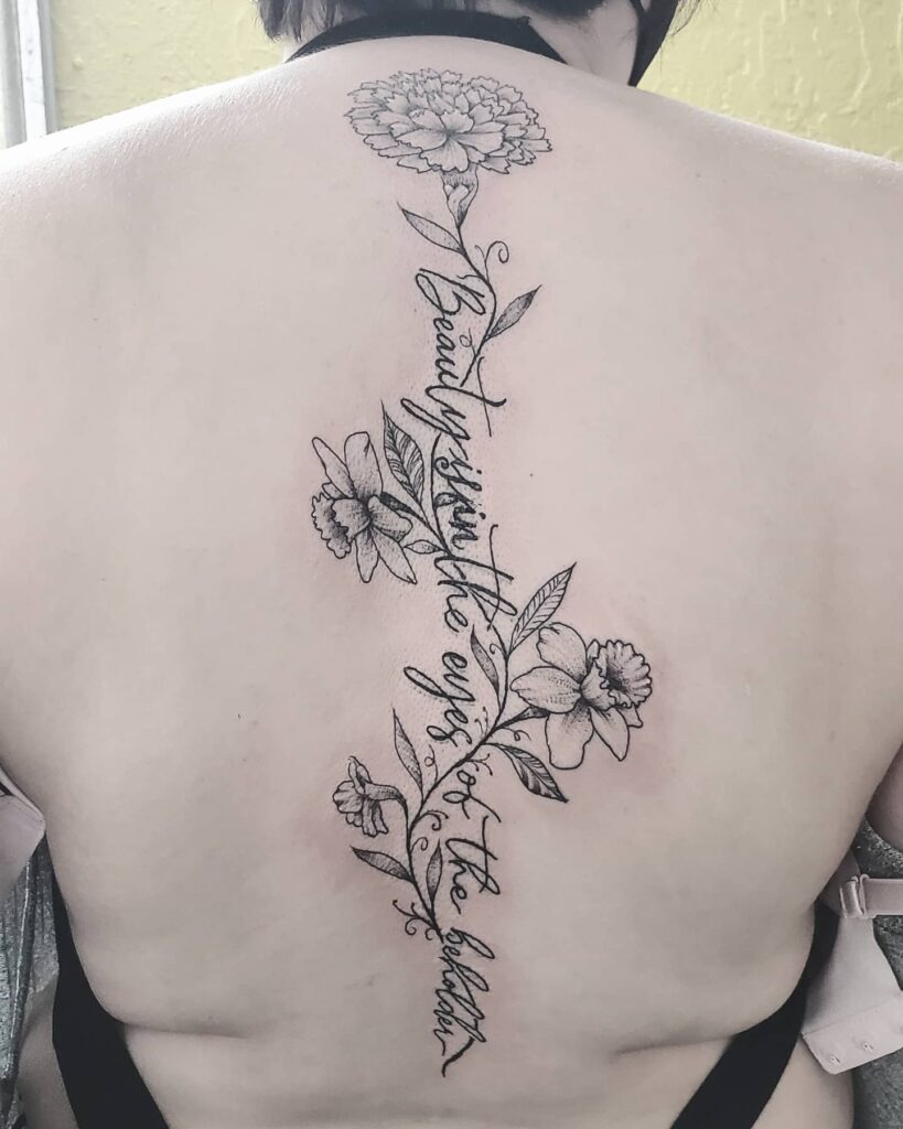 11+ Flower Spine Tattoo Ideas That Will Blow Your Mind! 19 Marigold Spine Tattoo With Quote