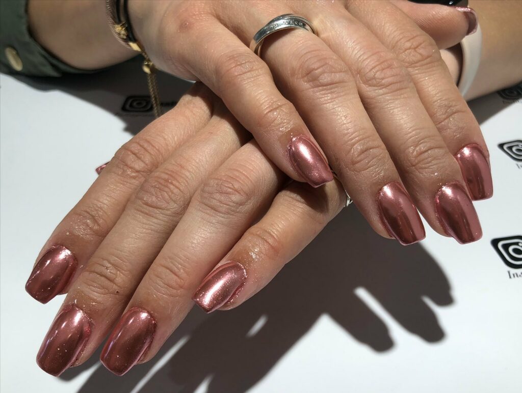Shine Bright with 50 Rose Gold Nail Designs for 2024 45 Metallic Rose Gold with Black Accents