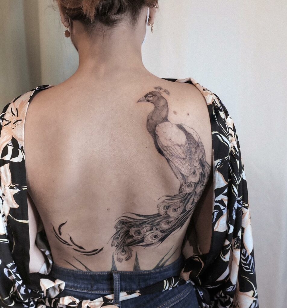 12+ Peacock Tattoo On Back Ideas To Inspire You! 12 Minimalistic Black and White Peacock Back Tattoo