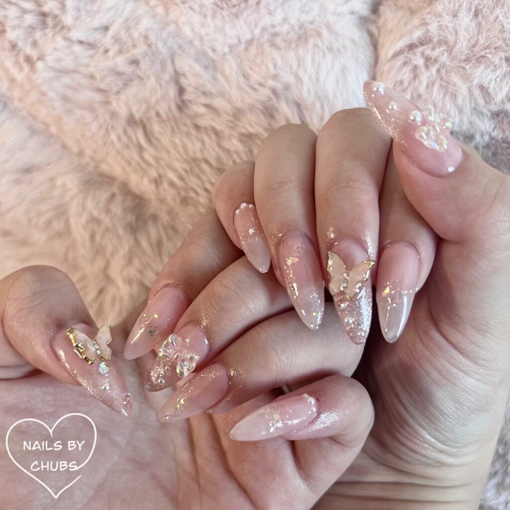 59 White Glitter Nail Designs To Try In 2024! 57 Pink nude combo with butterfly accents Glitter Nails
