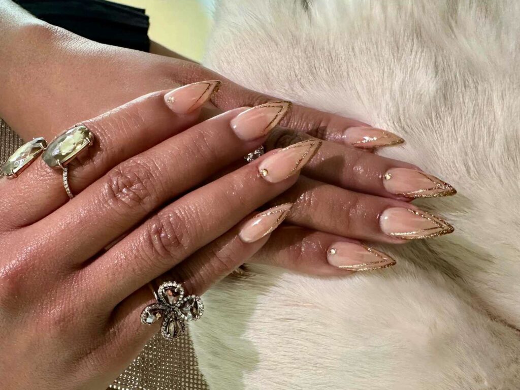 14 Latest Golden Globe Nail Ideas To Try in 2024! 14 Quinta Brunson's Champagne-Gold V-French