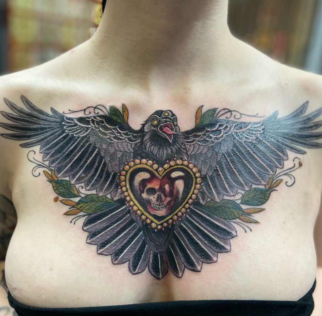 11+ Wings On Chest Tattoo Ideas That You Have To See To Believe! 19 Raven Tattoo With Wings Stretched On Chest