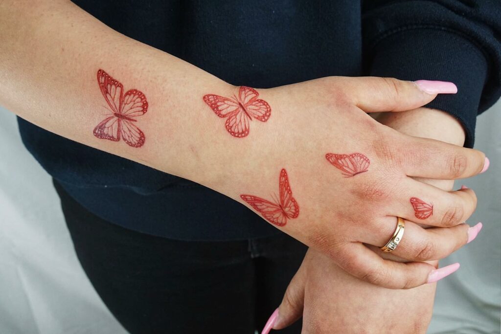 11+ Butterfly Finger Tattoo Ideas That Will Blow Your Mind! 13 Red Butterfly Finger Tattoo