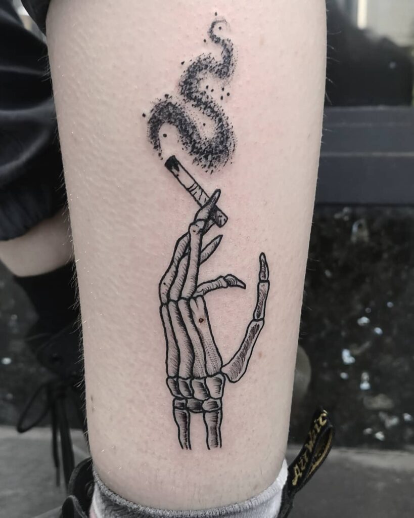 34 Hand Skeleton Tattoo Designs for 2024 19 Skeleton Hand with cigarette Tattoo