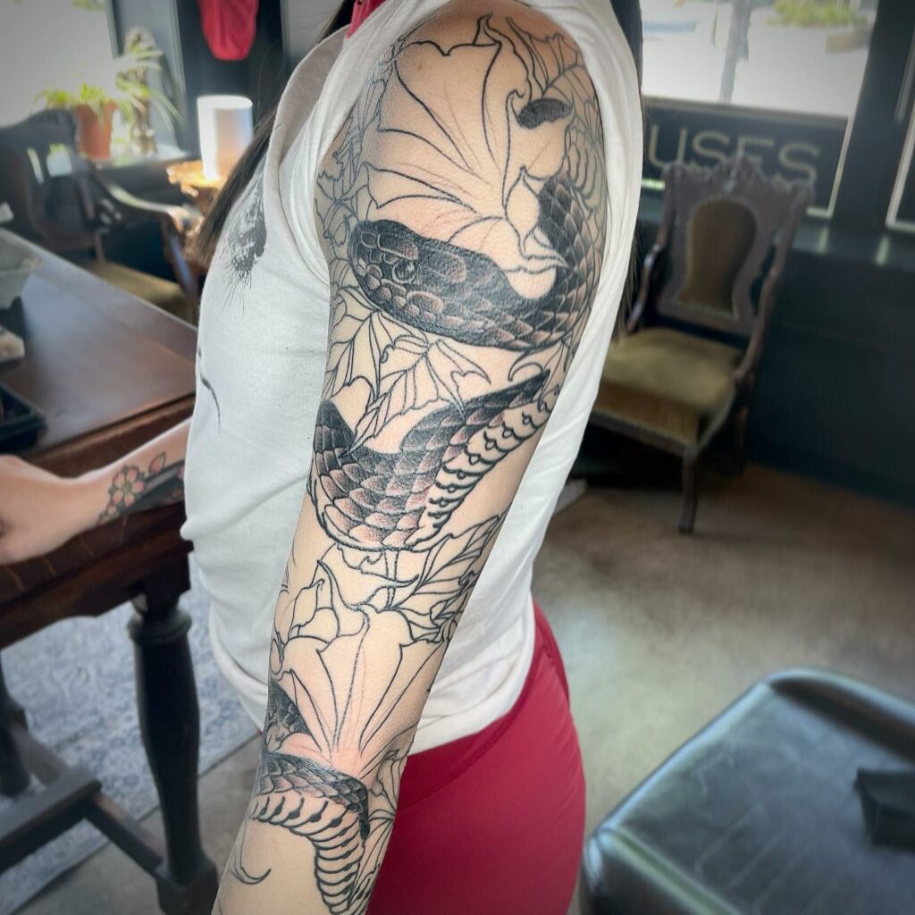 12+ Spaced Out Tattoo Sleeve Ideas To Inspire You! 14 Snake And Flowers Spaced Out Tattoo Sleeve
