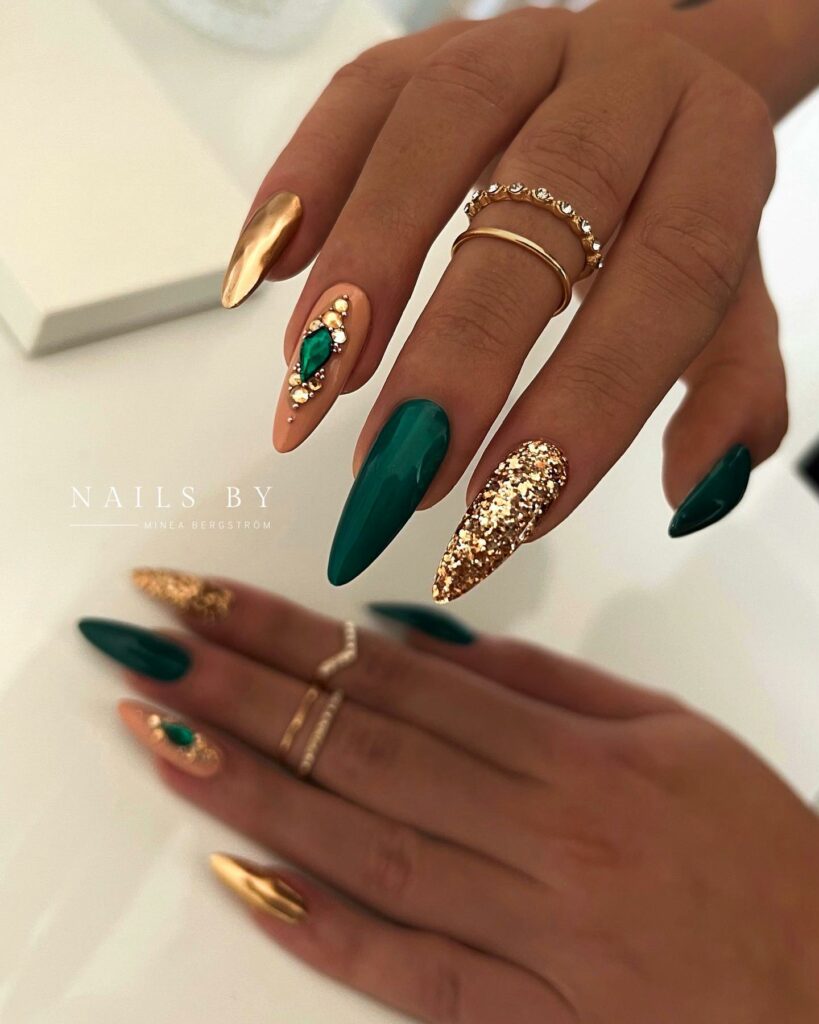 33 Latest Emerald Green and Gold Nail Ideas To Try In 2024! 12 Gem-Encrusted Stiletto Emerald Green and Gold Nails