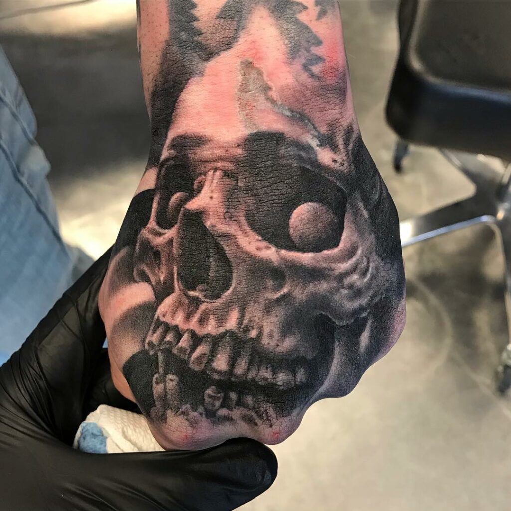 11+ Skeleton Face Hand Tattoo Ideas That Will Blow Your Mind! 16 Traditional Skeleton Face Hand Tattoo