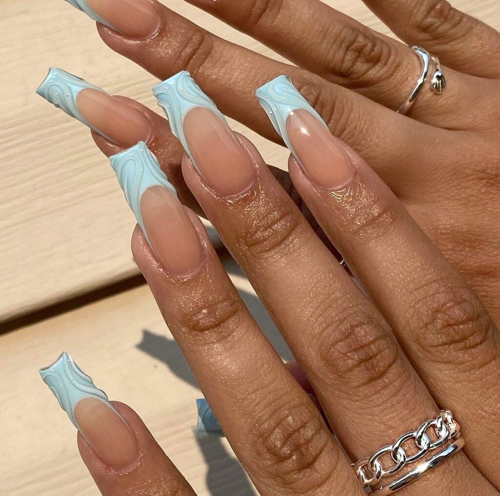 34 Latest Blue Acrylic Nail Designs To Try in 2024 11 Blue Acrylic Nails with Whimsical Marble Accents