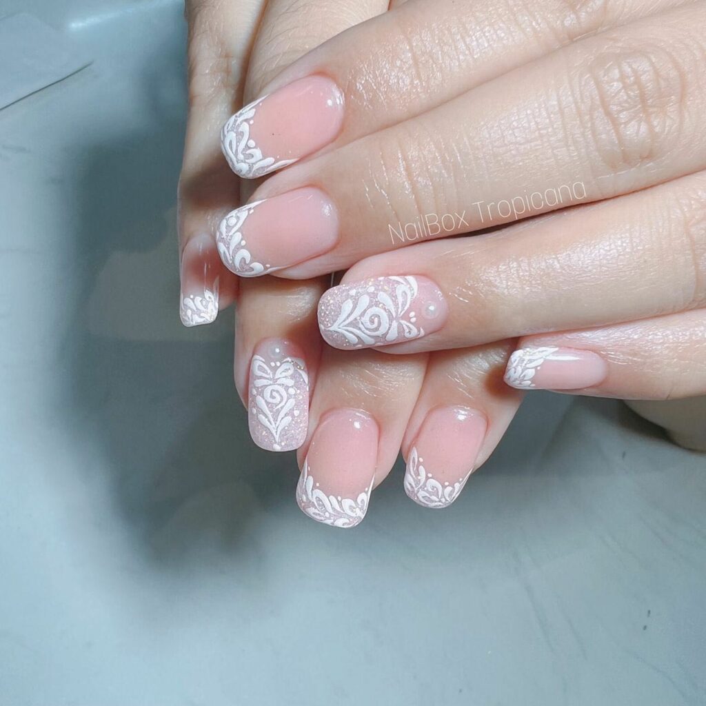 Experiment with 40 Fresh White Tip Nail Ideas for 2024 43 White Tips with Intricate Lace Designs