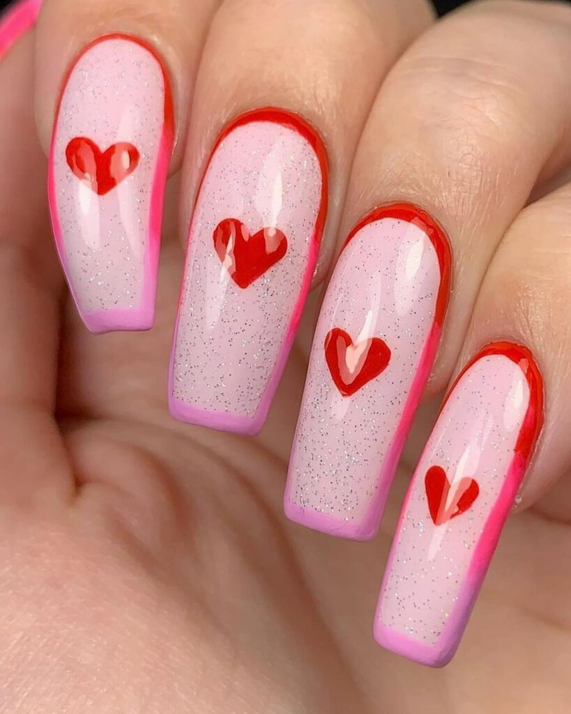14 Cute Valentine’s Day Nail Ideas To Try in 2024! đŸ’… 13 Romantic Pink Base Glitter Nails: Whimsical Hearts for Valentine's