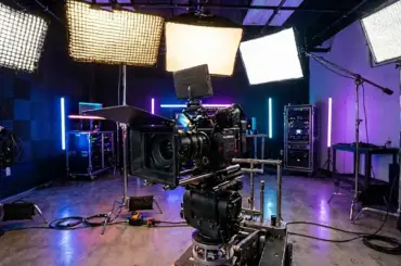Best Lights for Video Production – professional LED panel lights, softboxes, and RGB studio lighting illuminating a video camera setup for filmmaking and content creation.